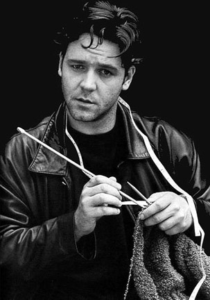 A young Russell Crowe poses with his knitting