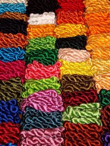 Hanks of brightly coloured English Silk Thread laid out on a market stall