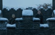 A shot from Game of Thrones with Arya and Sansa Stark standing on the snow-frosted battlements of Winterfell